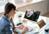 Woman working at desk with laptop showing finance dashboard