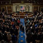 101-Year Senator? Iowa’s High-Stakes Gambit Legislative chamber audience stands and applauds