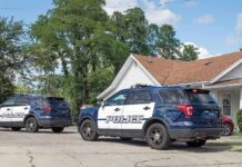 Puppy Horror Caught – Arrest In 24 Hours Two police SUVs parked near a suburban house