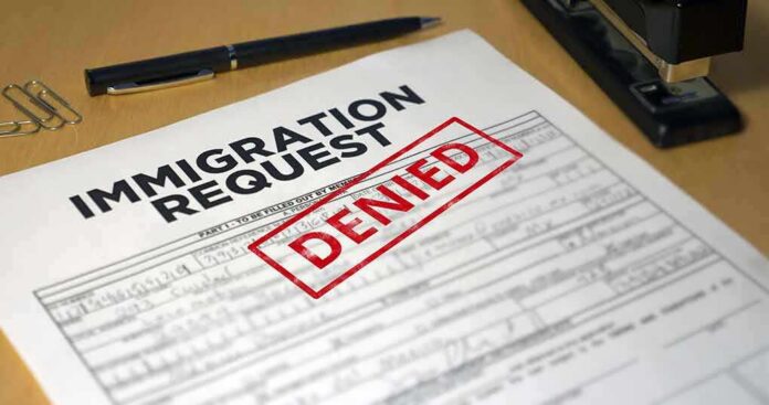 Immigration request form with denied stamp on a desk