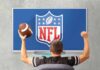 football fan cheering in front of a TV showing the NFL logo