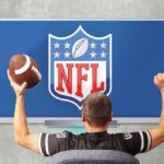 football fan cheering in front of a TV showing the NFL logo