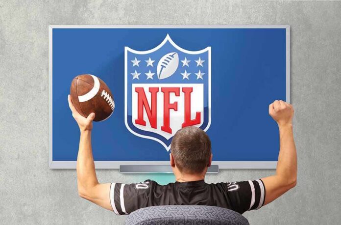 football fan cheering in front of a TV showing the NFL logo