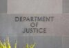 Department of Justice building sign on stone wall