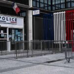 Police station entrance with barriers and French flag colors