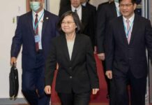 Tsai Ing-wen walking in a hallway with suited aides