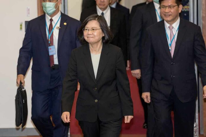 Tsai Ing-wen walking in a hallway with suited aides