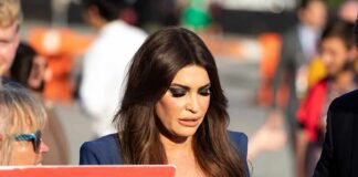 Kimberly Guilfoyle walking outdoors among a crowd