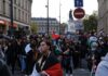 Hundreds of Schools Shut as Protests Spread Brian Folkerts and Ricardo Santos at a street protest with flags and a large crowd
