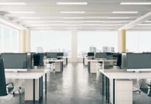 Layoff Shock: Netflix Targets The Engine Room Open-plan office with rows of desks and monitors