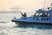 American Forces Blow Up Suspected Spy Boat U.S. Navy patrol boat with armed crew on the water