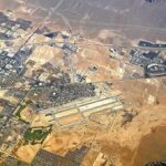 American Killed – Shock at Saudi Hub Aerial view of desert city with airport and highways