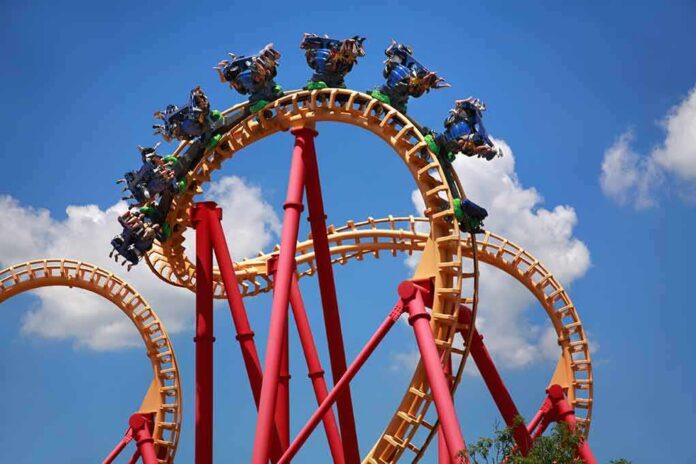 Roller coaster train twists through a vertical loop