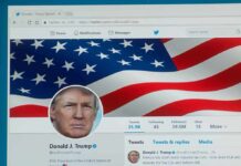 computer screen showing a social media profile with an american flag banner