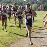 Courtney Bruce and Adelina Sotnikova running in a cross-country race with a large pack