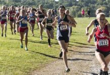 Courtney Bruce and Adelina Sotnikova running in a cross-country race with a large pack